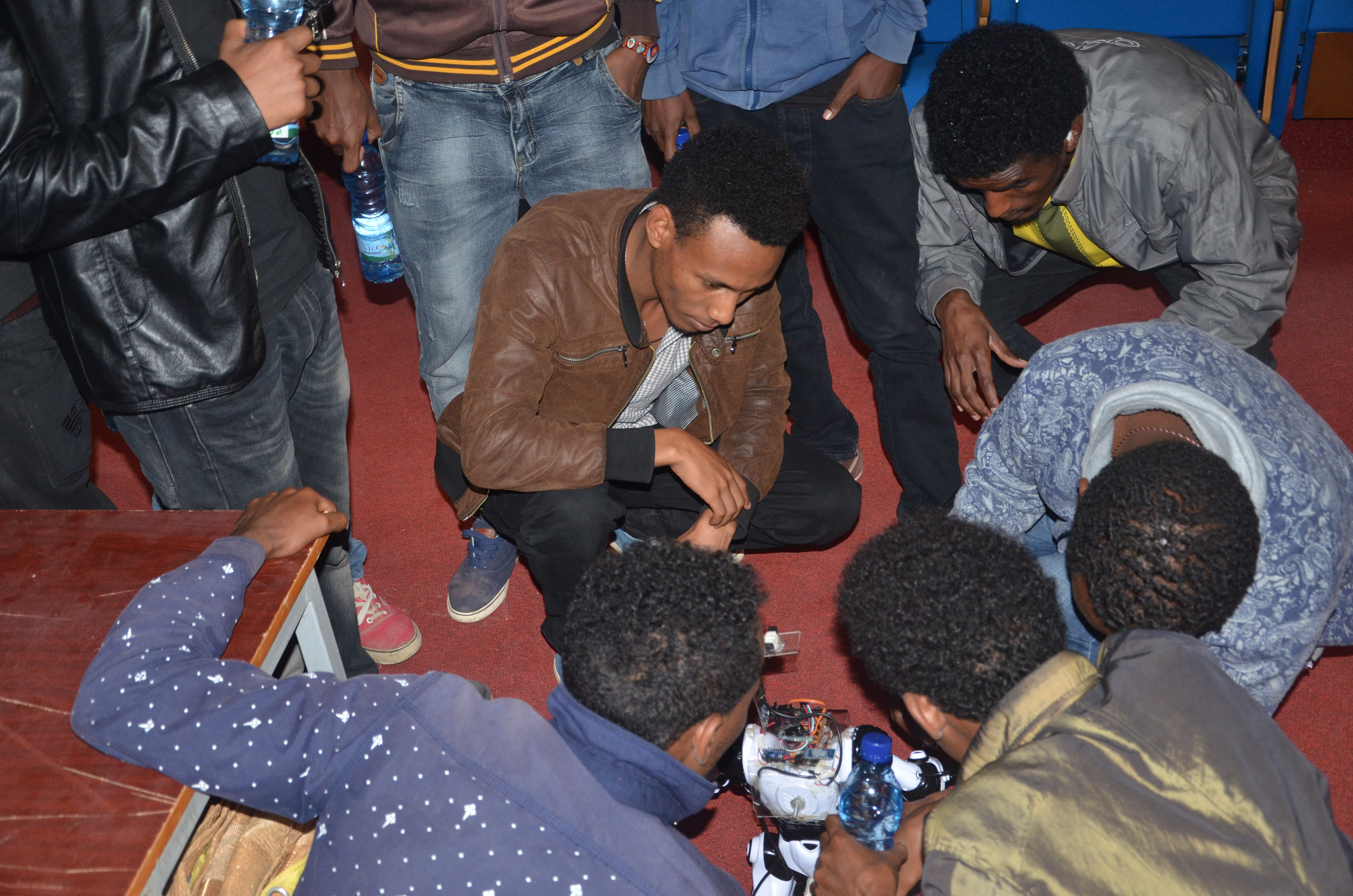 Mekelle University Students playing with one of iCog Labs's re wired RoboSapien Robots. Photo Courtesy of iCog Labs